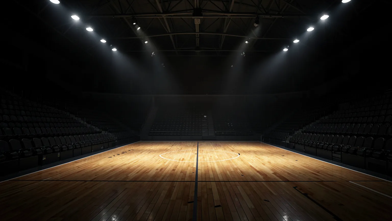 Pabellón de baloncesto vacío con la pista de madera brillante iluminada por focos cenitales
